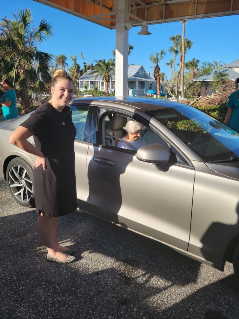 woman standing next to car with female passenger