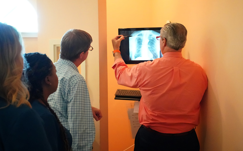Dr. James and Dr. Kueber looking over a patient's X-ray